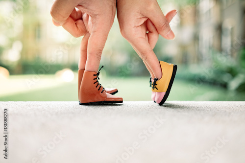 Couple hand finger walk to kiss with shoe concept, Feet of the kissing couple 