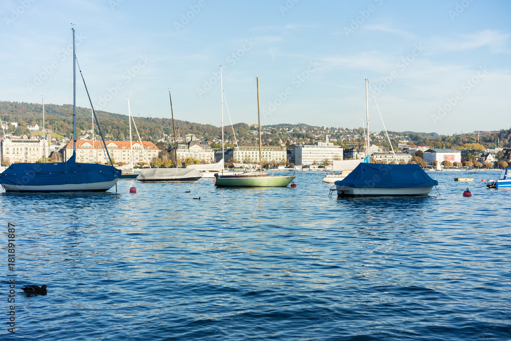 boats on lake zurich in summer with city background