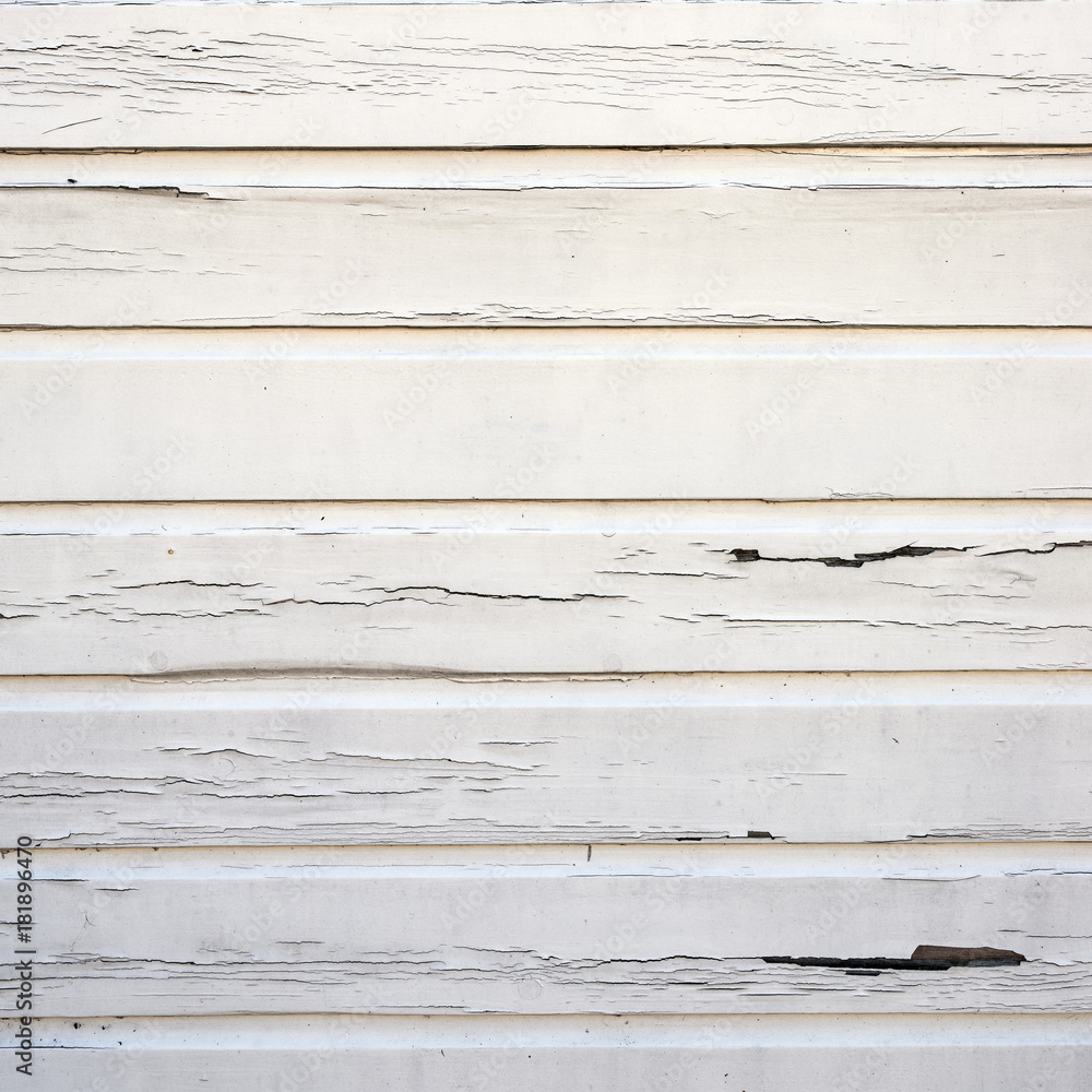 Obraz premium peeling white paint on horizontal wooden planks of shed wall