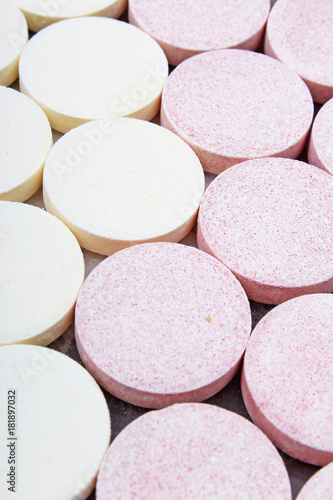 Stack of vitamin mineral supplement effervescent tablets pattern texture. Multivitamin supplement tablet. Soluble Vitamin. Fizzy tablet. Orange flavored effervescent tablets as background.
