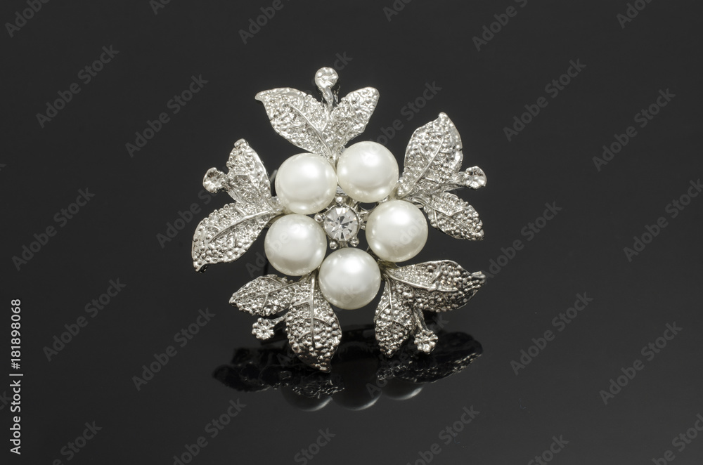 silver brooch flower with pearls isolated on black silver brooch flower with pearls isolated on black