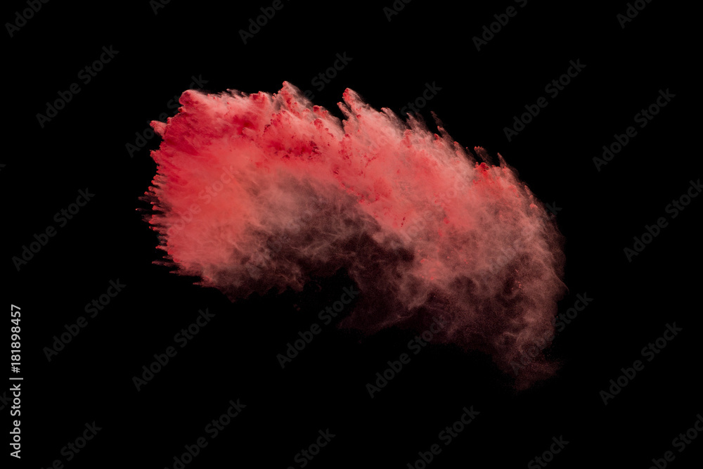 Explosion of red powder isolated on black background
