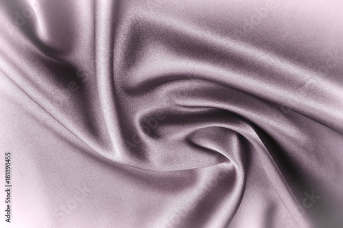 Texture fabric background. Black white silk fabric. Fragment of an abstract background of luxurious fabrics or liquid waves or wavy folds of a grunge silk texture of a satin velvet material