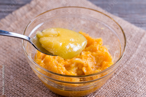 Honey and pumpkin puree in a glass bowl photo