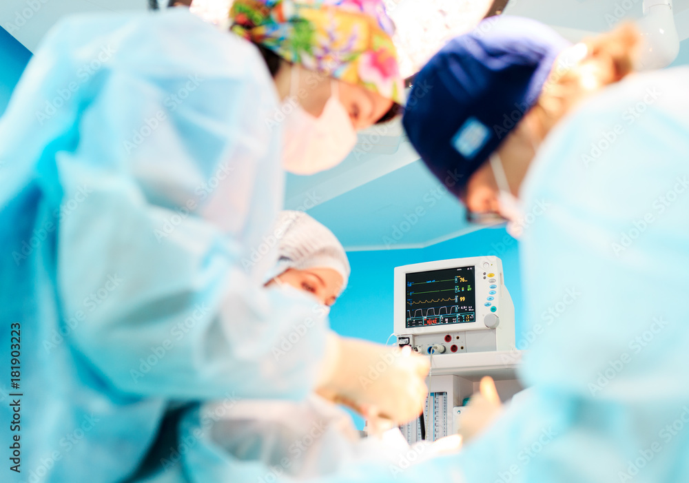 Surgeons operating a patient during surgery Surgeons operating a patient during surgery
