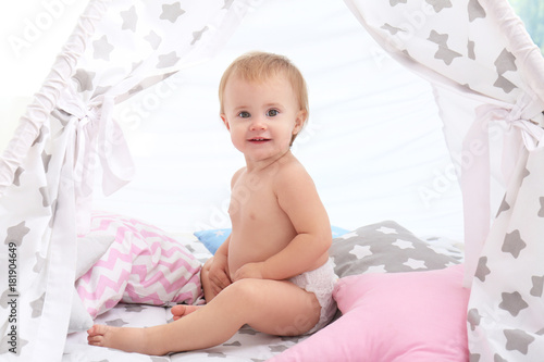 Cute little baby sitting in...