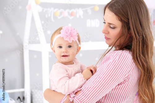 Young mother holding cute b...