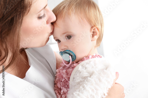 Young mother holding cute b...