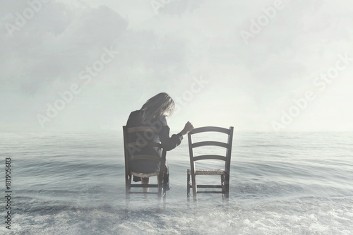 Photography sad woman looks nostalgically at her lover's empty chair