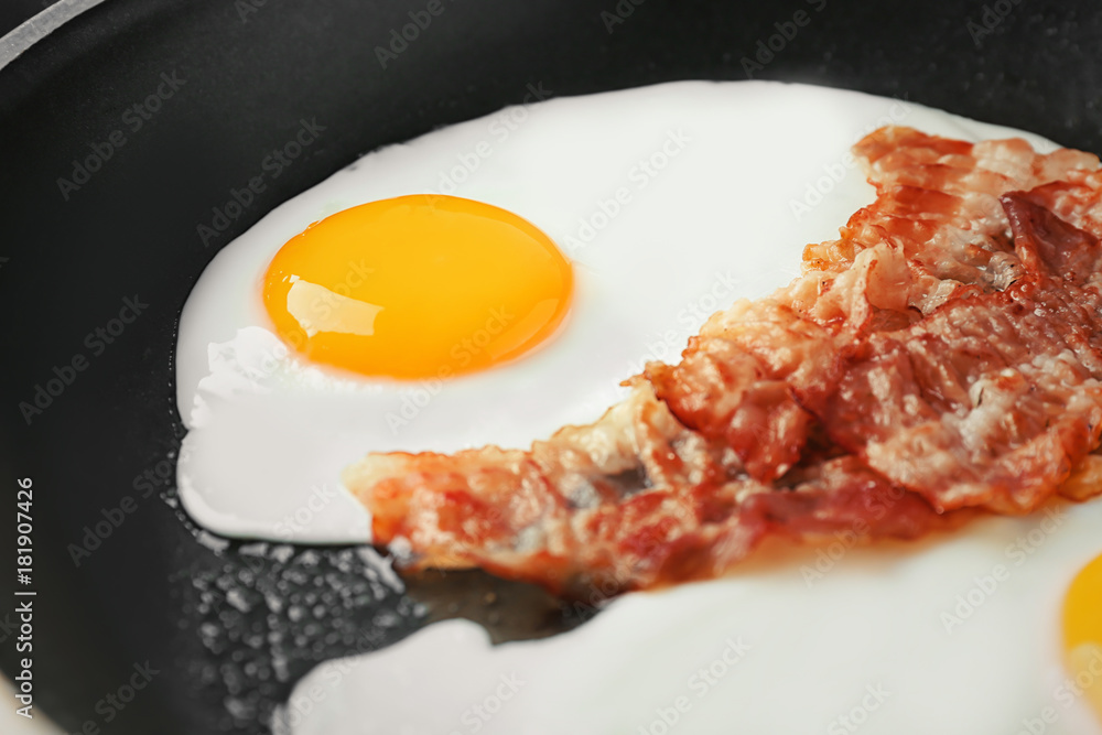 Frying pan with egg and bacon, closeup Frying pan with egg and bacon, closeup