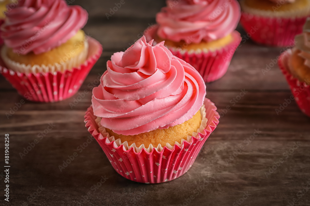 Yummy cupcakes on wooden table Yummy cupcakes on wooden table
