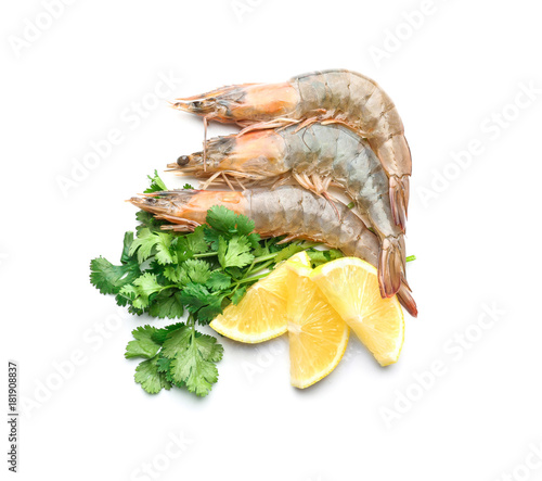 Fresh shrimps with slices of lemon on white background