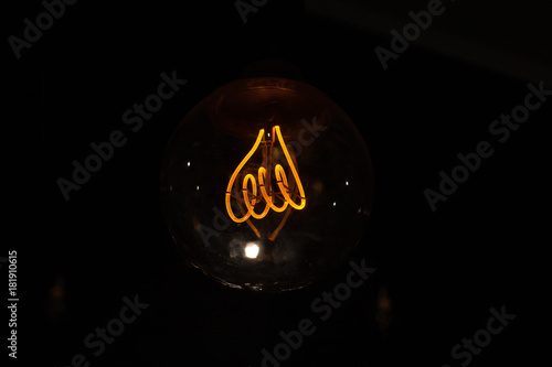 Light bulbs switched on and off, isolated on black background photo