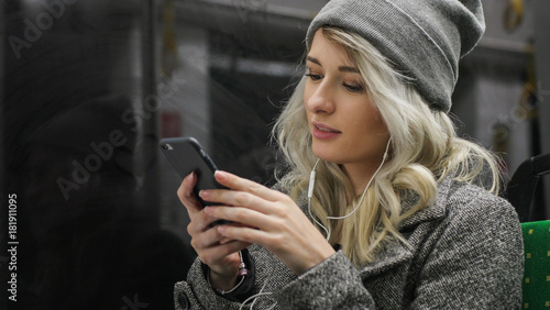 Young teenage girl using her cell phone in public transportation