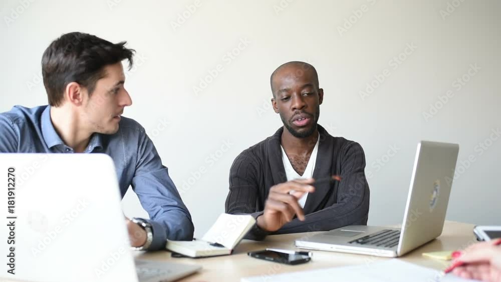 Multiracial business people working together connected with technological devices like tablet and notebook - teamwork, business, working concept Multiracial business people working together connected with technological devices like tablet and notebook - teamwork, business, working concept