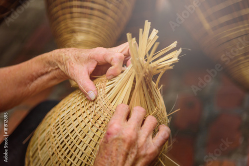 Obraz na plátně Vietnamese fishermen are doing basketry for fishing equipment at morning in Thu Sy Village, Vietnam