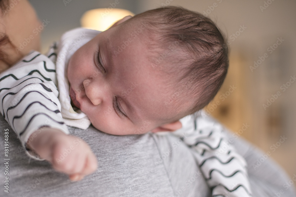 Mother holding her newborn baby son after birth on arms. Concept of love and family. Newborn baby boy. New life Mother holding her newborn baby son after birth on arms. Concept of love and family. Newborn baby boy. New life