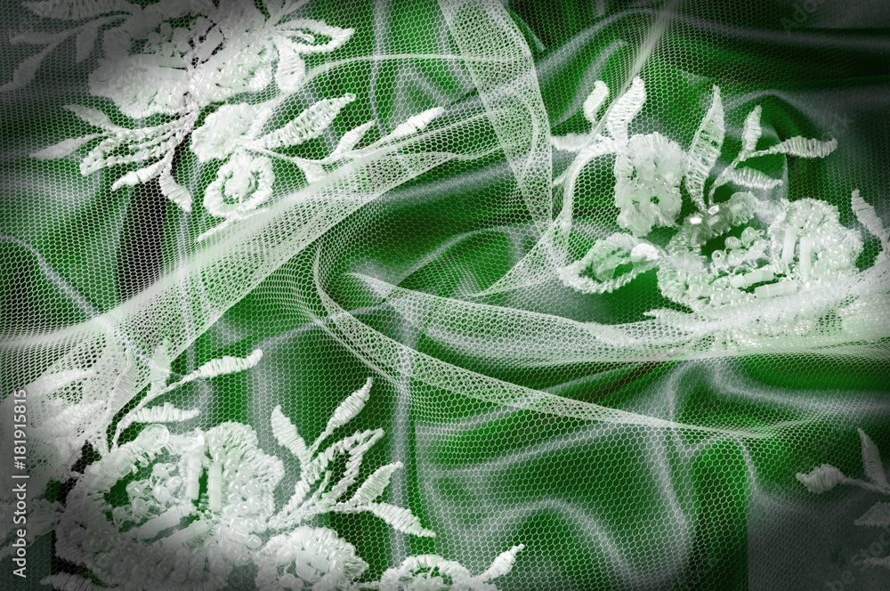 Texture, background, pattern. Lacy white fabric. Flowers made of lace