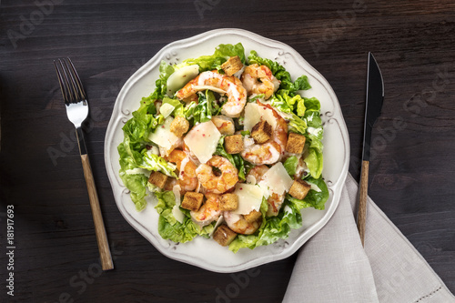 Overhead photo of shrimp Caesar salad with copyspace
