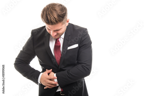 Business man standing holding appendix like hurting