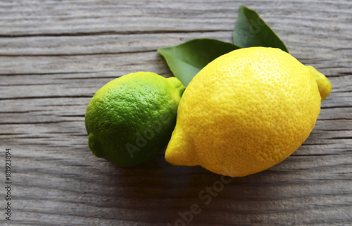 Lemon and lime.Fresh ripe organic lemon and lime fruits on old wooden background.Healthy eating or aromatherapy concept.Selective focus.