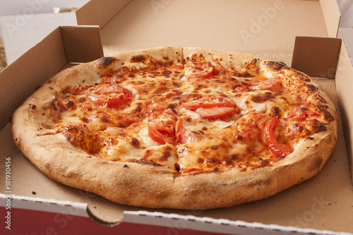Pizza texture pattern background. Margharita vegetarian pizza close up. Pizza delivery with pizza box banner ad or cover background for your project. Pizza cover.