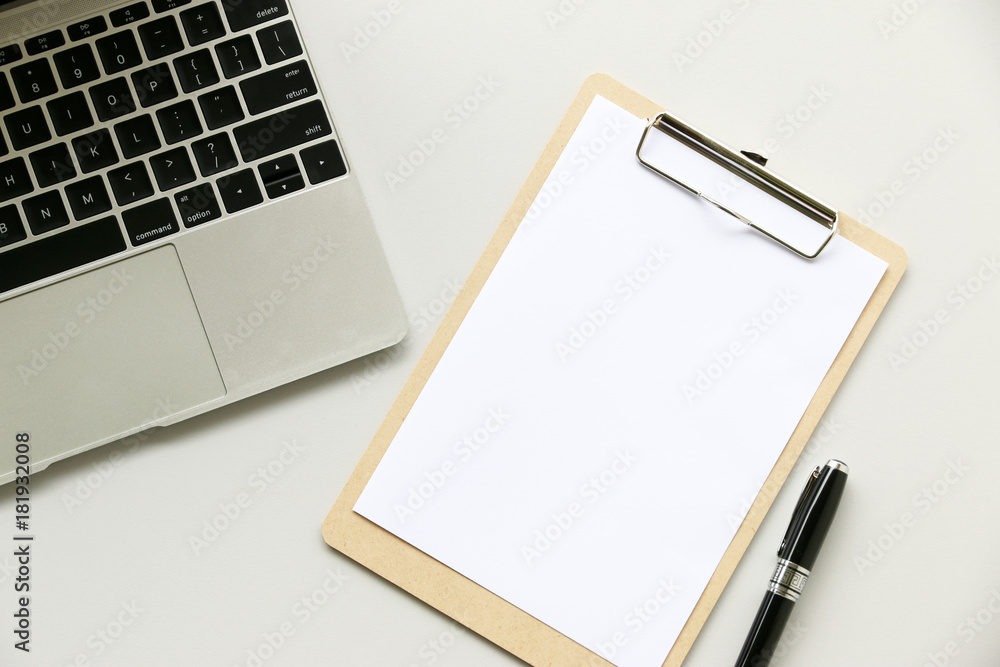 Office table with Laptop computer,pen,Clipboard and cactus, copy space,Top view, flat lay Office table with Laptop computer,pen,Clipboard and cactus, copy space,Top view, flat lay