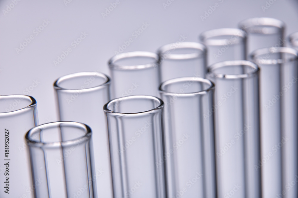 Row of empty test tubes gray background Row of empty test tubes gray background