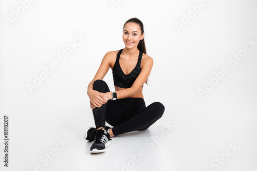 Portrait of a smiling asian fitness woman