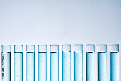 Row of tubes with blue liquid frontal view