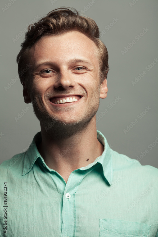 Male beauty, boy next door concept. Portrait of smiling 30-year-old man  standing over gray background. Close up. Classic style. Wavy glossy blond  hair. Text space. Studio shot Stock Photo | Adobe Stock