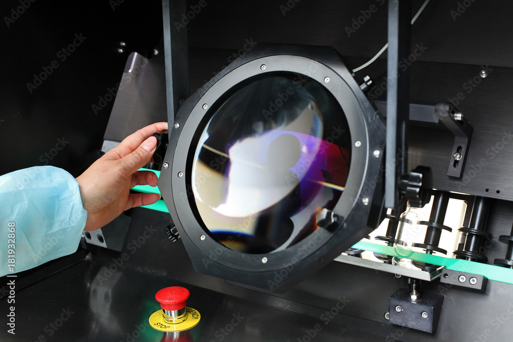 Quality Control vials for injection. Individual checks vial under a microscope. New pharmaceutical. Production of sterile medications. Pharmacology and people together. The ampoule under a microscope.