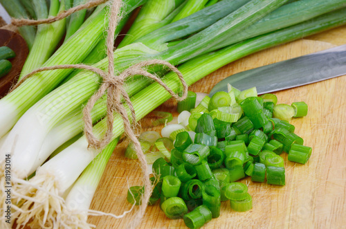 Spring onions are rich in vitamins,minerals and natural compound.
Green onions or Spring onions on wooden board cutting.