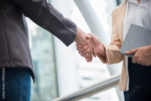two business women shaking hands
