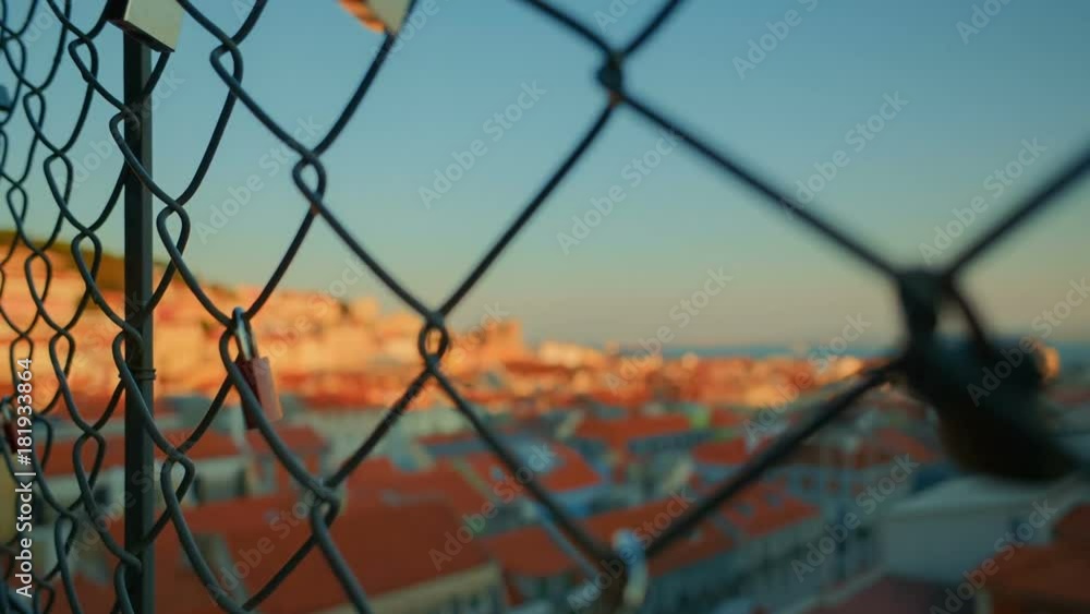 From Lisbon with love - Rack focus golden hour shot revealing the downtown of Lisbon, Portugal from love padlocks From Lisbon with love - Rack focus golden hour shot revealing the downtown of Lisbon, Portugal from love padlocks