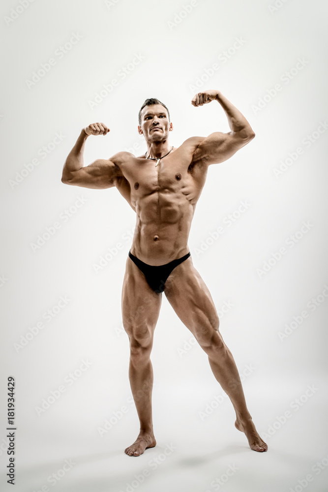 athletic guy - bodybuilder, pose on white background athletic guy - bodybuilder, pose on white background