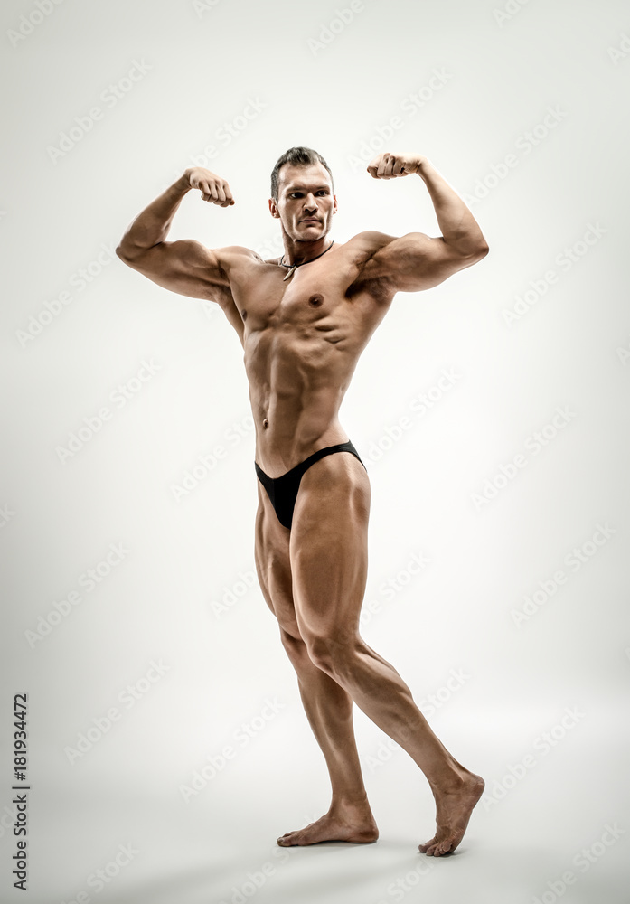 athletic guy - bodybuilder, pose on white background athletic guy - bodybuilder, pose on white background