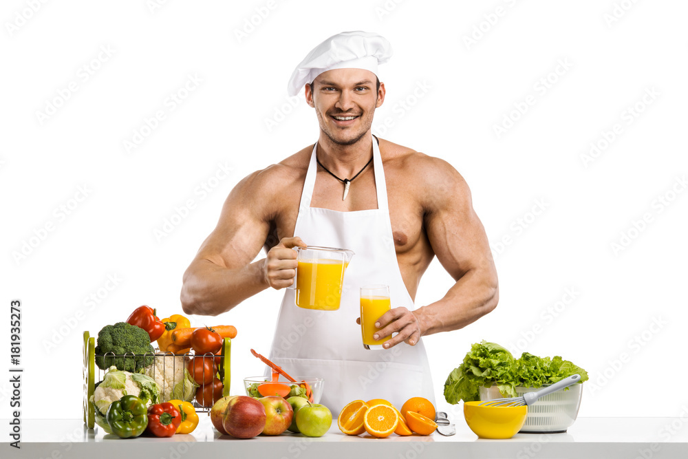 Man bodybuilder cook, cooking freshly squeezed juice and vegetables salad Man bodybuilder cook, cooking freshly squeezed juice and vegetables salad