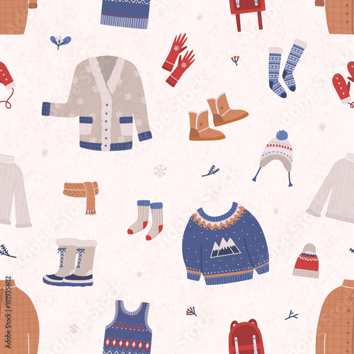 Seamless pattern with winter clothes and outerwear on light background. Backdrop with warm seasonal clothing or apparel. Cartoon vector illustration for wallpaper, wrapping paper, textile print.