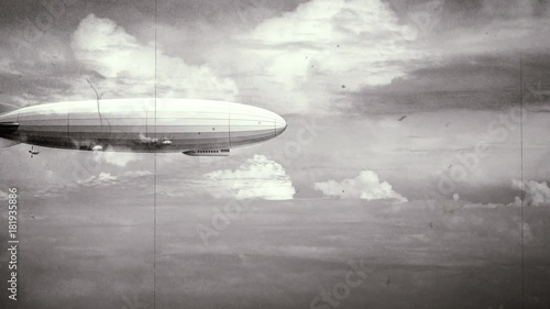 Legendary huge zeppelin airship on sky with clouds. Black and white retro stylization, old film. Flying balloon animation. Big dirigible, spinning propellers and rudder. Long zeppelin, rigid airship.