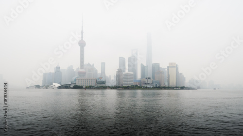 View of Shanghai business district skyline across the Huangpu river  with pollution mist.
