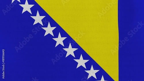 Loopable: Flag of Bosnia and Herzegovina...Bosnia and Herzegovina official flag gently waving in the wind. Highly detailed fabric texture for 4K resolution. 15 seconds loop. photo