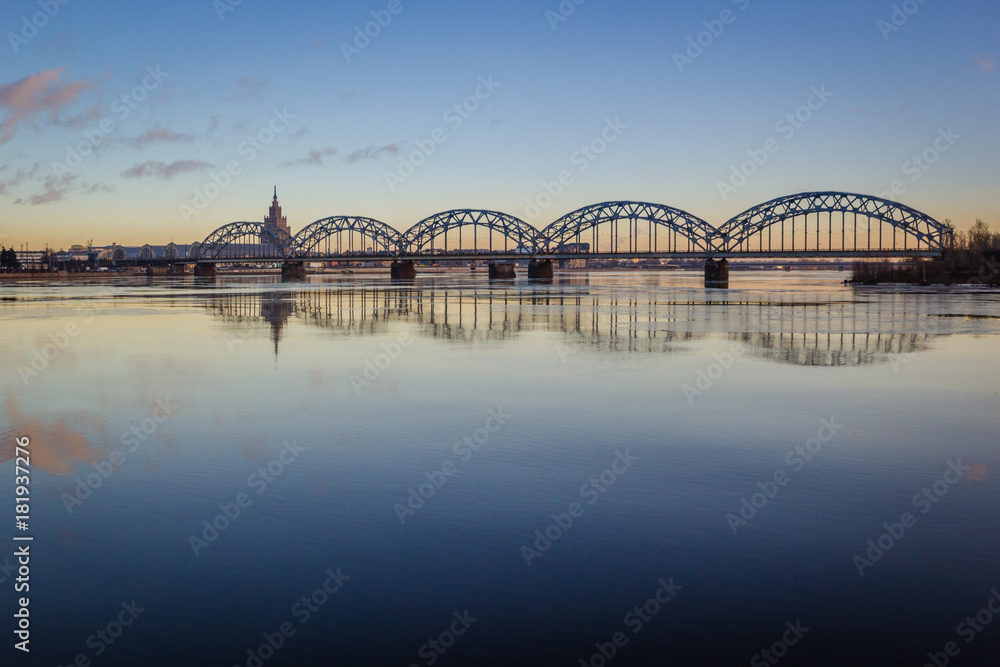 Stunning cloudy sunset at bridge at Riga, Latvia