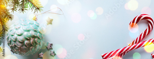 art light Blue Christmas card background; Holidays background with Xmas tree decoration