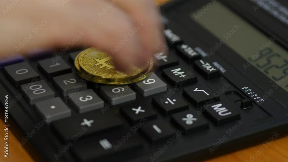 Male Hand Put Bitcoin On A Calculator Male Hand Put Bitcoin On A Calculator