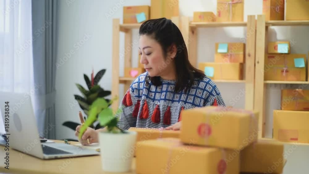 Woman Working at home with Online Business or SME Concept. Young owner happy woman Start up for Business Online happy with orders. Woman Working at home with Online Business or SME Concept. Young owner happy woman Start up for Business Online happy with orders.