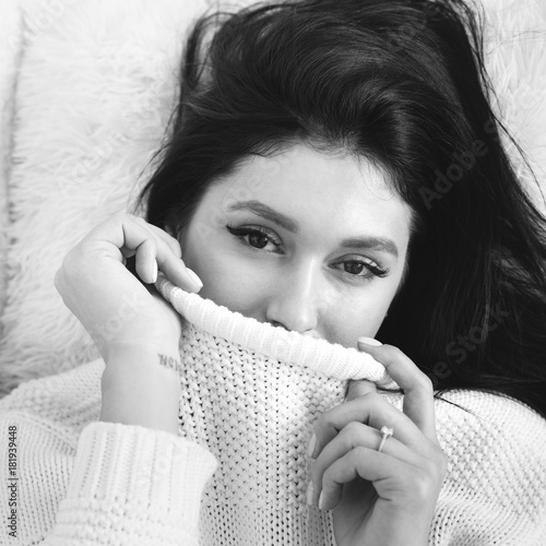 Beauty monochrome portrait of gorgeous brunnete wearing white knitted sweater