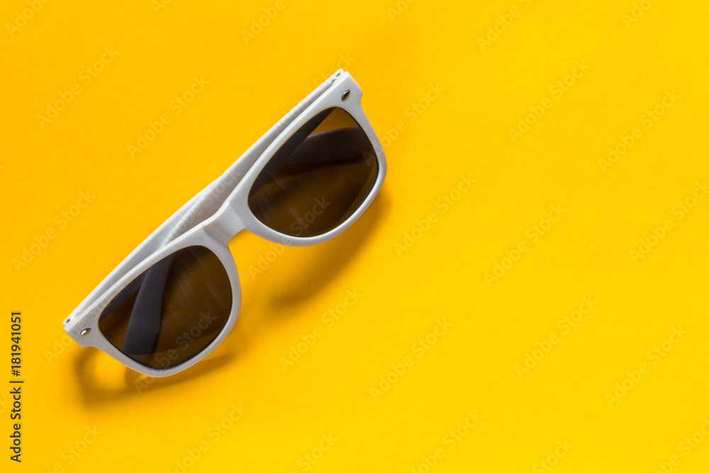 Sunglasses white frame on a yellow background Sunglasses white frame on a yellow background