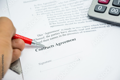 contracts agreement sign on document paper with red pen