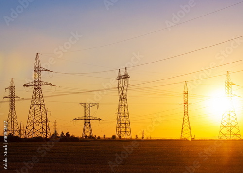 High-voltage power transmission line. Energy pillars. At sunset, dawn. high-tension